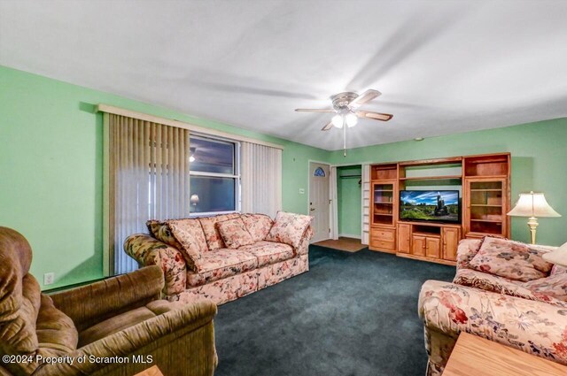 living room featuring ceiling fan and carpet floors