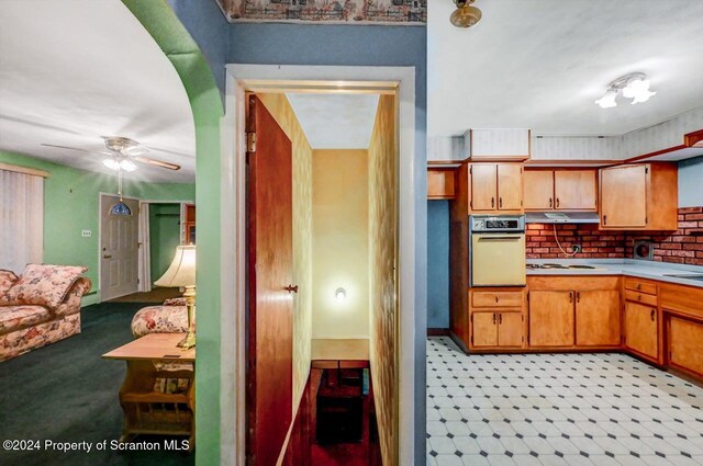 kitchen featuring wall oven, white gas stovetop, tasteful backsplash, and ceiling fan