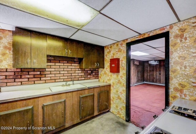 kitchen featuring a paneled ceiling and sink