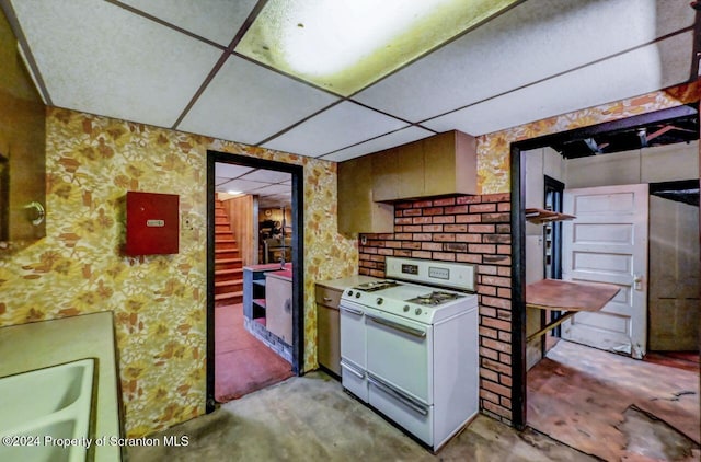 kitchen featuring a paneled ceiling, sink, and white range