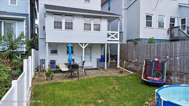 126 Crown Ave, Scranton, PA 18505 - rear view of house with a trampoline, a fenced backyard, and a patio