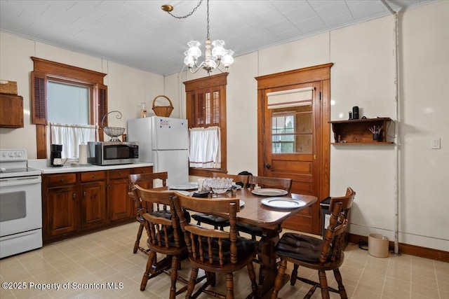 126 Crown Ave, Scranton, PA 18505 - dining space featuring light floors, a chandelier, and crown molding