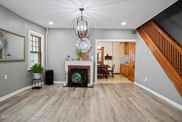 126 Crown Ave, Scranton, PA 18505 - living area featuring light wood-style floors, a chandelier, stairs, recessed lighting, and a brick fireplace