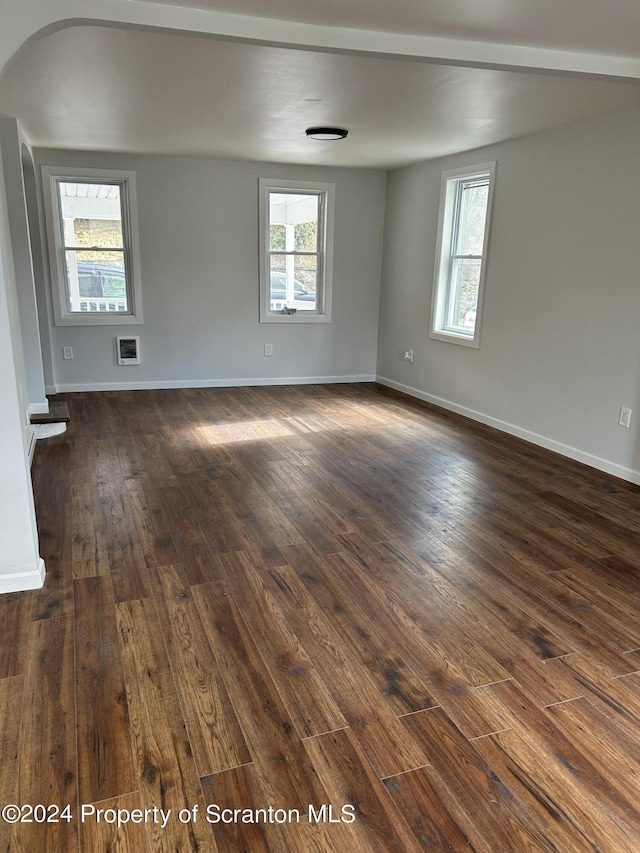 spare room featuring dark hardwood / wood-style flooring