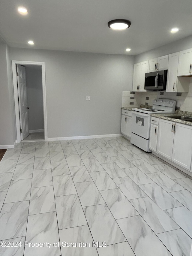 kitchen featuring light stone countertops, tasteful backsplash, sink, electric stove, and white cabinets