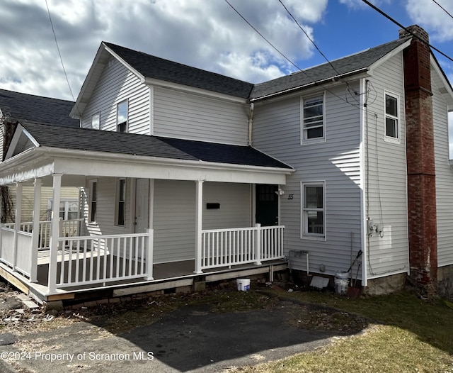 back of property with covered porch