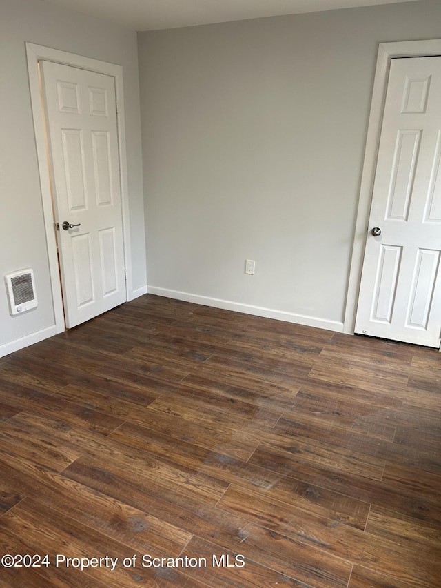 unfurnished room featuring dark hardwood / wood-style flooring