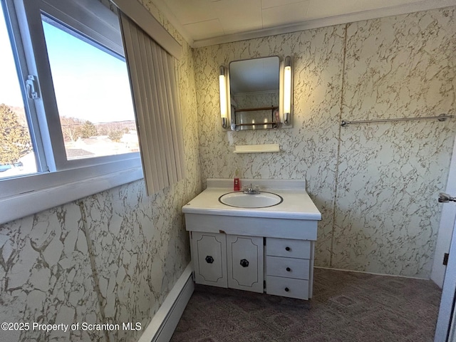 bathroom featuring baseboard heating and vanity