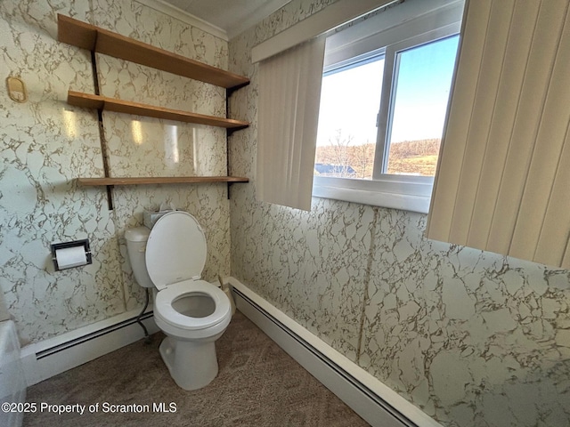 bathroom featuring a baseboard heating unit and toilet