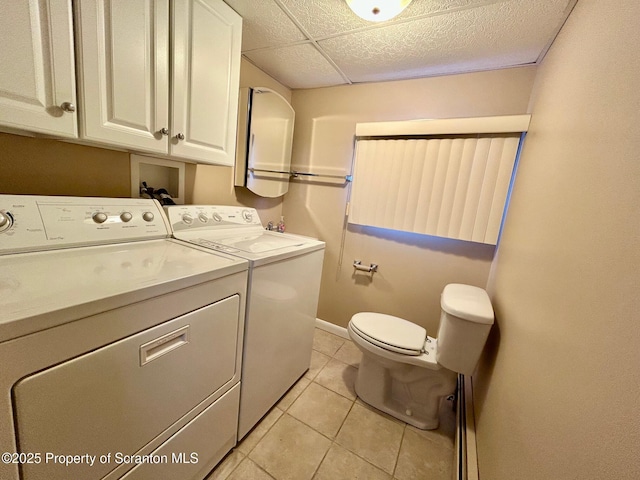 clothes washing area featuring light tile patterned floors and washer and clothes dryer