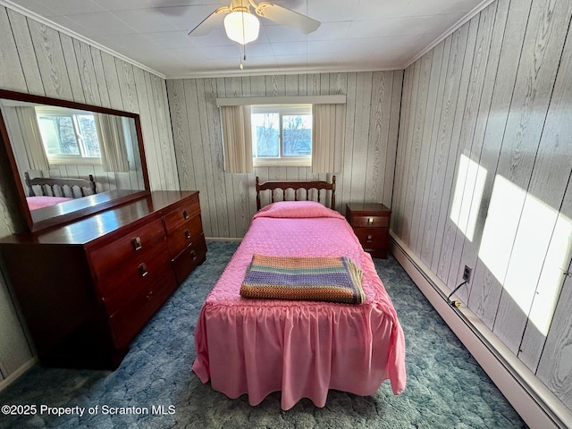 bedroom with baseboard heating, ceiling fan, ornamental molding, and dark carpet