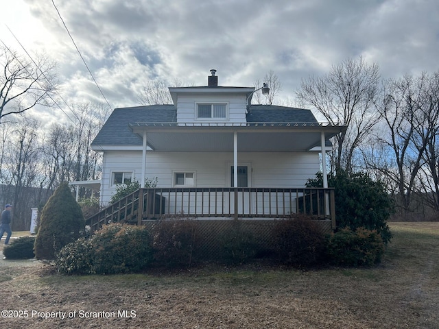 rear view of property with a porch