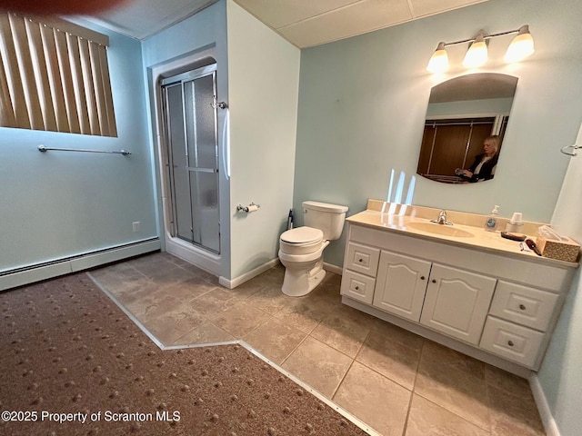 bathroom with walk in shower, tile patterned floors, toilet, vanity, and a baseboard heating unit