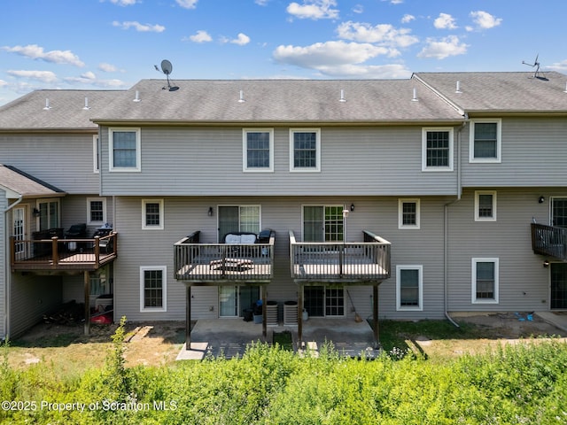 rear view of house with a patio, cooling unit, and a deck