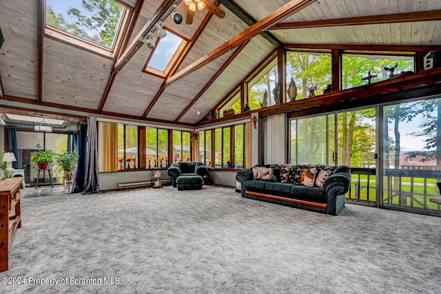 sunroom / solarium with plenty of natural light, ceiling fan, a baseboard heating unit, and vaulted ceiling with skylight