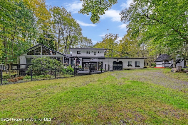 rear view of house featuring a lawn