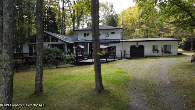 back of house with a lawn