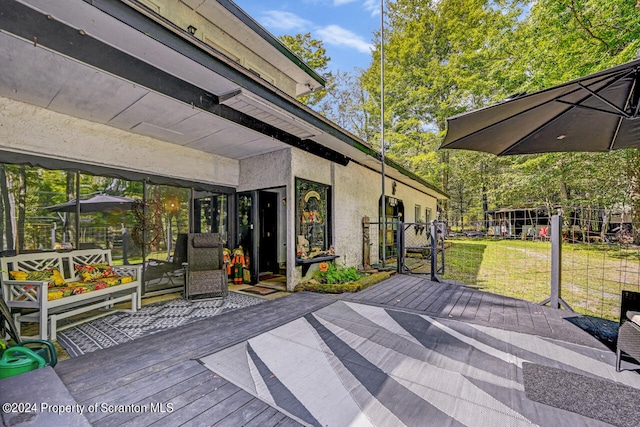 wooden terrace with a lawn