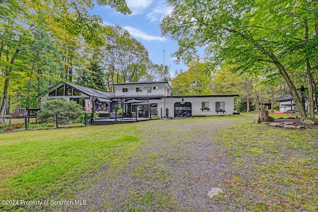 rear view of property with a lawn