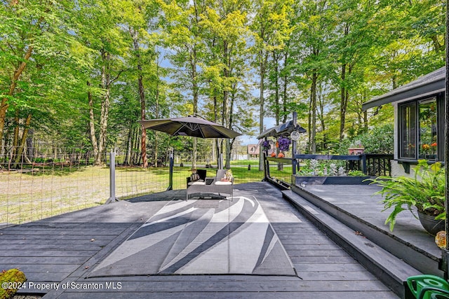 wooden terrace with a lawn