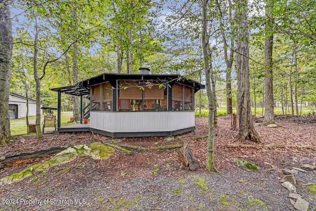 rear view of property with a sunroom