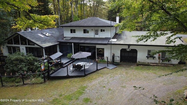 back of house featuring a sunroom