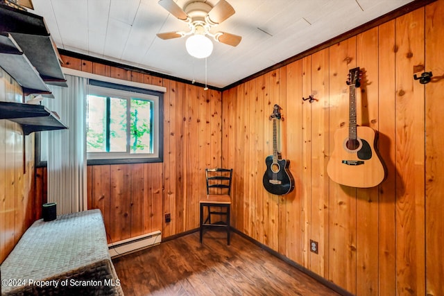 bedroom with dark hardwood / wood-style flooring, a baseboard heating unit, and wood walls