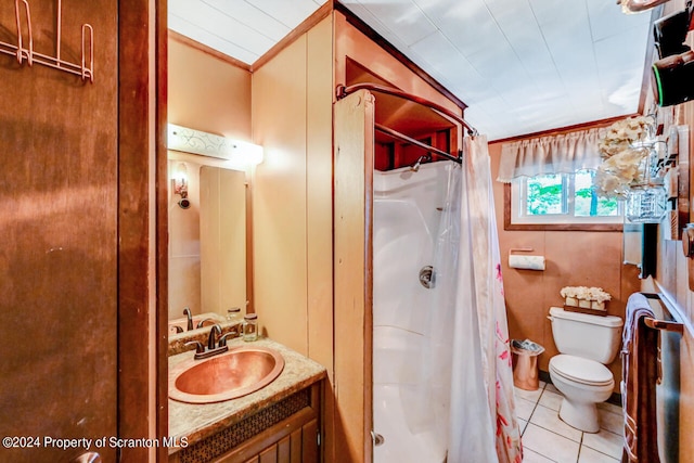 bathroom with tile patterned floors, curtained shower, vanity, and toilet