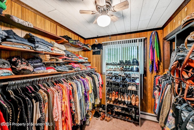 walk in closet with light carpet