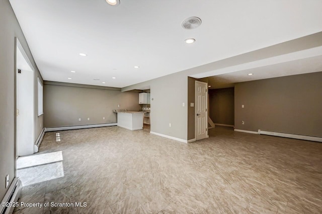 27 Emerson Dr, Moosic, PA 18507 - unfurnished living room featuring a baseboard radiator, recessed lighting, and baseboards