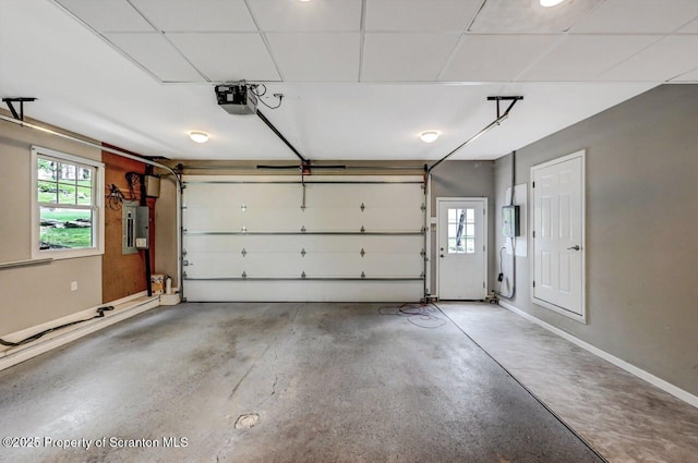 27 Emerson Dr, Moosic, PA 18507 - garage with electric panel, a garage door opener, and baseboards
