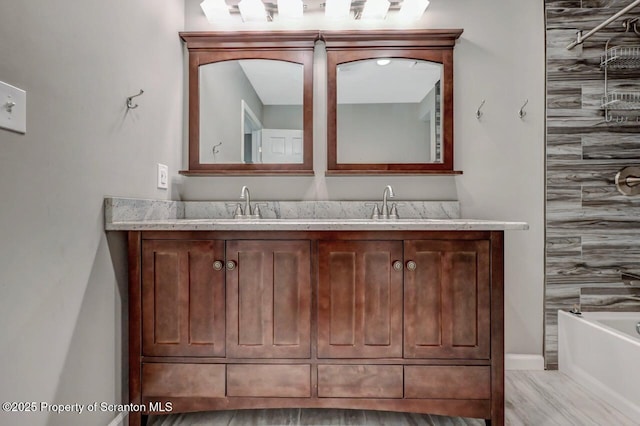 27 Emerson Dr, Moosic, PA 18507 - full bathroom featuring a bath, double vanity, and baseboards