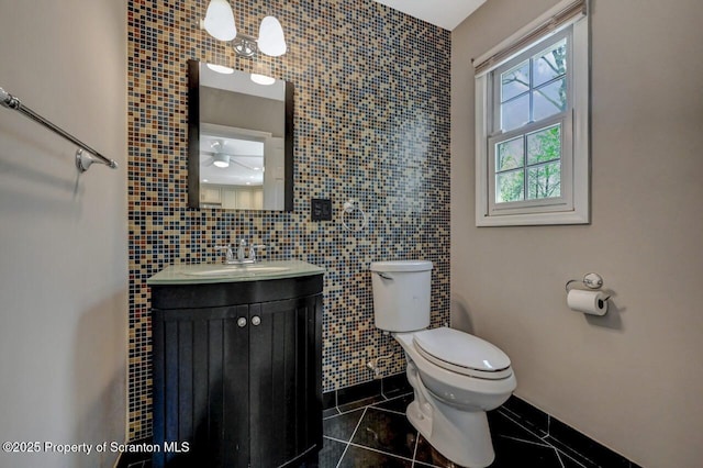 27 Emerson Dr, Moosic, PA 18507 - bathroom featuring tile patterned flooring, toilet, tile walls, vanity, and a ceiling fan