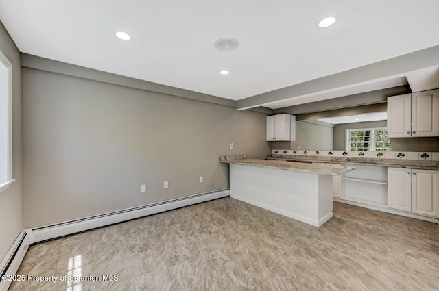 27 Emerson Dr, Moosic, PA 18507 - kitchen with a baseboard heating unit, recessed lighting, white cabinetry, a peninsula, and light stone counters