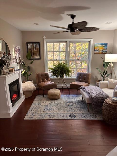 27 Emerson Dr, Moosic, PA 18507 - living area featuring ceiling fan, a glass covered fireplace, wood finished floors, and baseboard heating