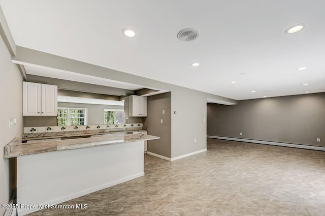 27 Emerson Dr, Moosic, PA 18507 - kitchen featuring white cabinets, recessed lighting, light stone countertops, a peninsula, and baseboards