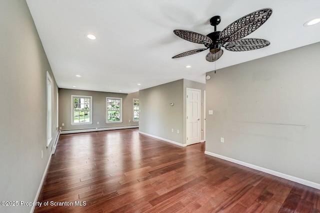 27 Emerson Dr, Moosic, PA 18507 - unfurnished living room featuring ceiling fan, a baseboard radiator, wood finished floors, baseboards, and recessed lighting