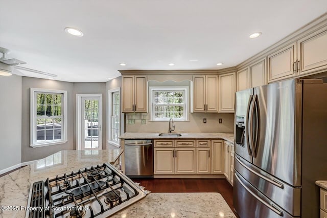 27 Emerson Dr, Moosic, PA 18507 - kitchen featuring appliances with stainless steel finishes, dark wood finished floors, light stone countertops, a sink, and recessed lighting