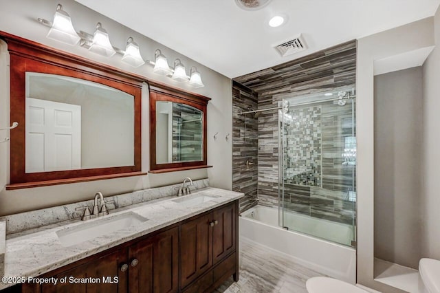 27 Emerson Dr, Moosic, PA 18507 - bathroom with toilet, double vanity, enclosed tub / shower combo, and recessed lighting