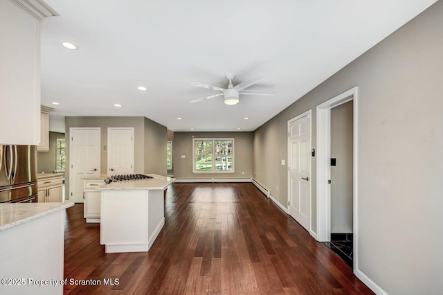 27 Emerson Dr, Moosic, PA 18507 - kitchen with appliances with stainless steel finishes, ceiling fan, dark wood finished floors, a kitchen island, and light stone counters