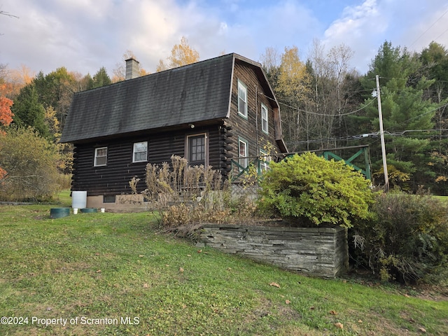 view of side of property with a yard