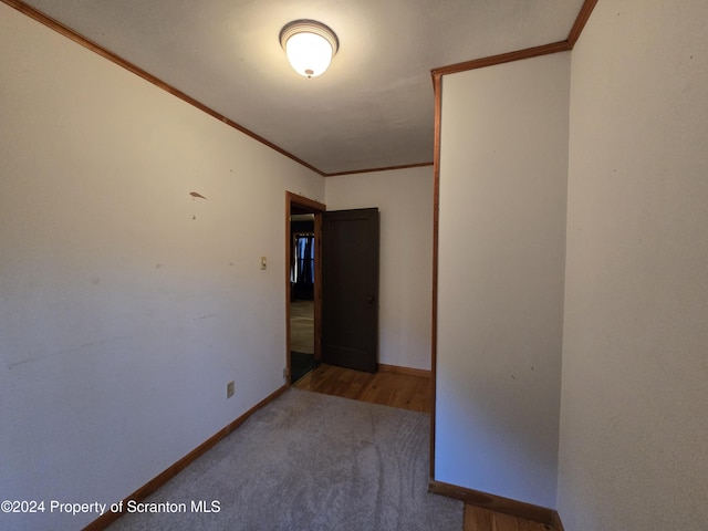 carpeted spare room with crown molding