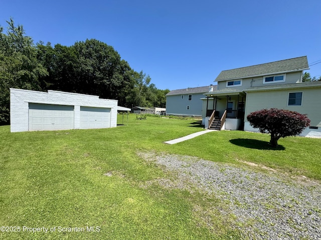 633 Thomas St, Eynon, PA 18403 - view of grassy yard with a garage and an outdoor structure