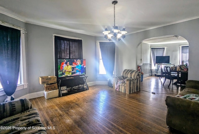 1310 Washburn St, Scranton, PA 18504 - living area with arched walkways, a chandelier, crown molding, baseboards, and hardwood / wood-style flooring