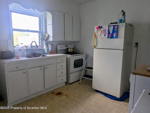 1310 Washburn St, Scranton, PA 18504 - kitchen featuring white appliances, a sink, white cabinets, and light floors