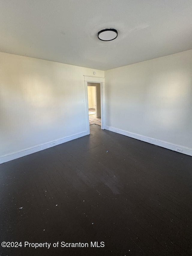 empty room with dark wood-type flooring