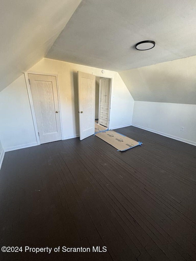 bonus room featuring dark hardwood / wood-style floors and lofted ceiling