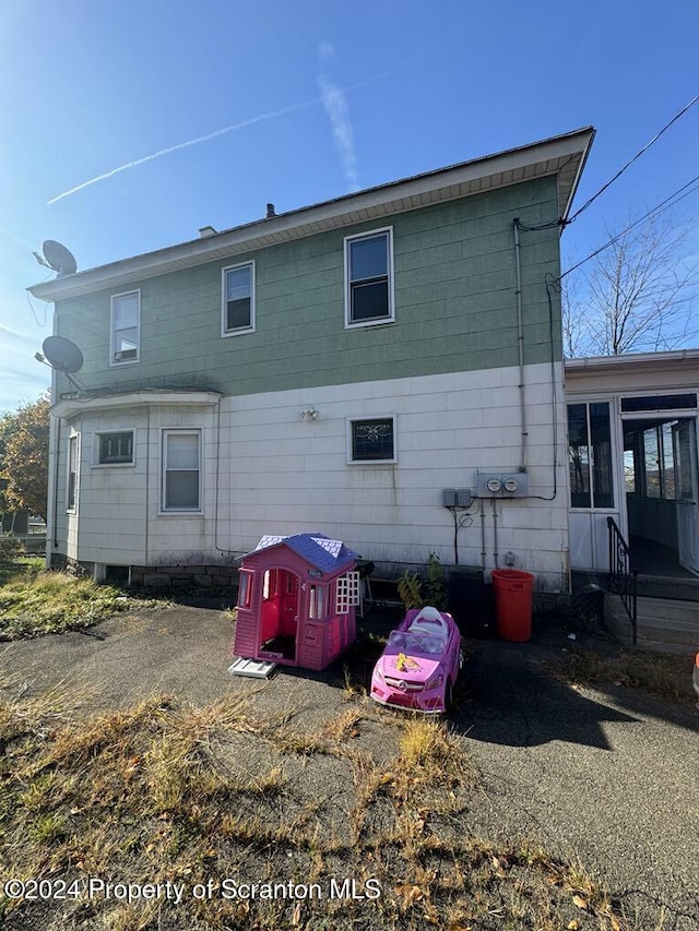 back of house featuring a sunroom