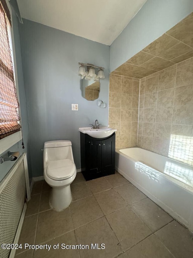 bathroom with a washtub, tile patterned floors, vanity, and toilet