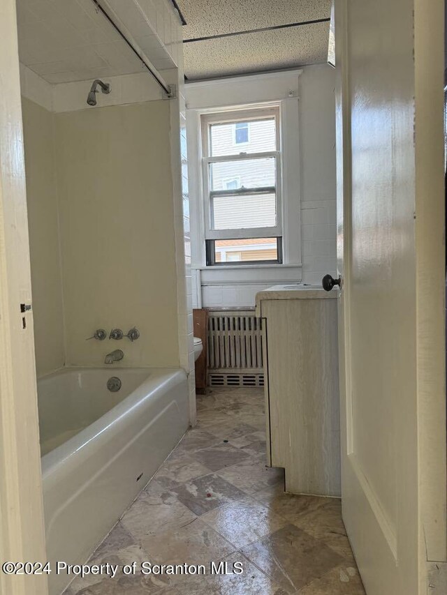 bathroom with shower / bath combination and toilet